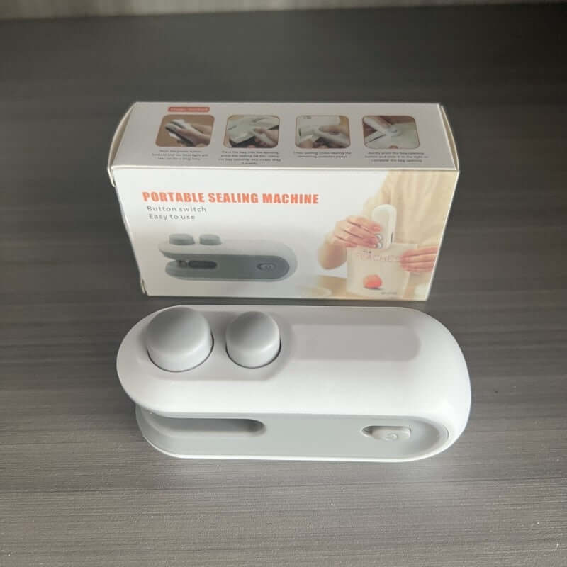 A white Mini 2-in-1 Rechargeable Heat Sealer being used to seal a snack bag, showcasing its compact, handheld ergonomic design.