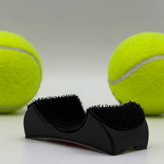 PadelGrab clip-on ball picker between two yellow balls