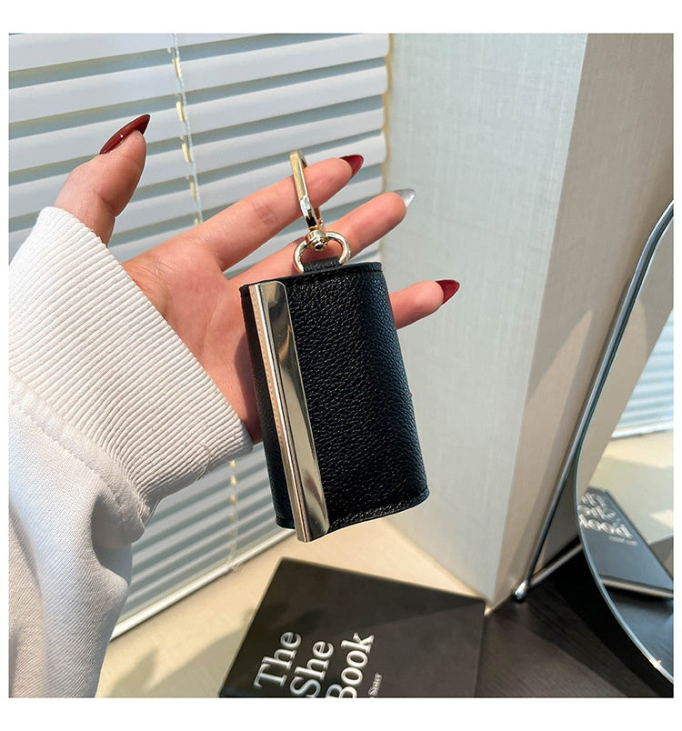 Foldable Lightweight Shoulder Bag key ring capsule tote held in hand with stylish nails.