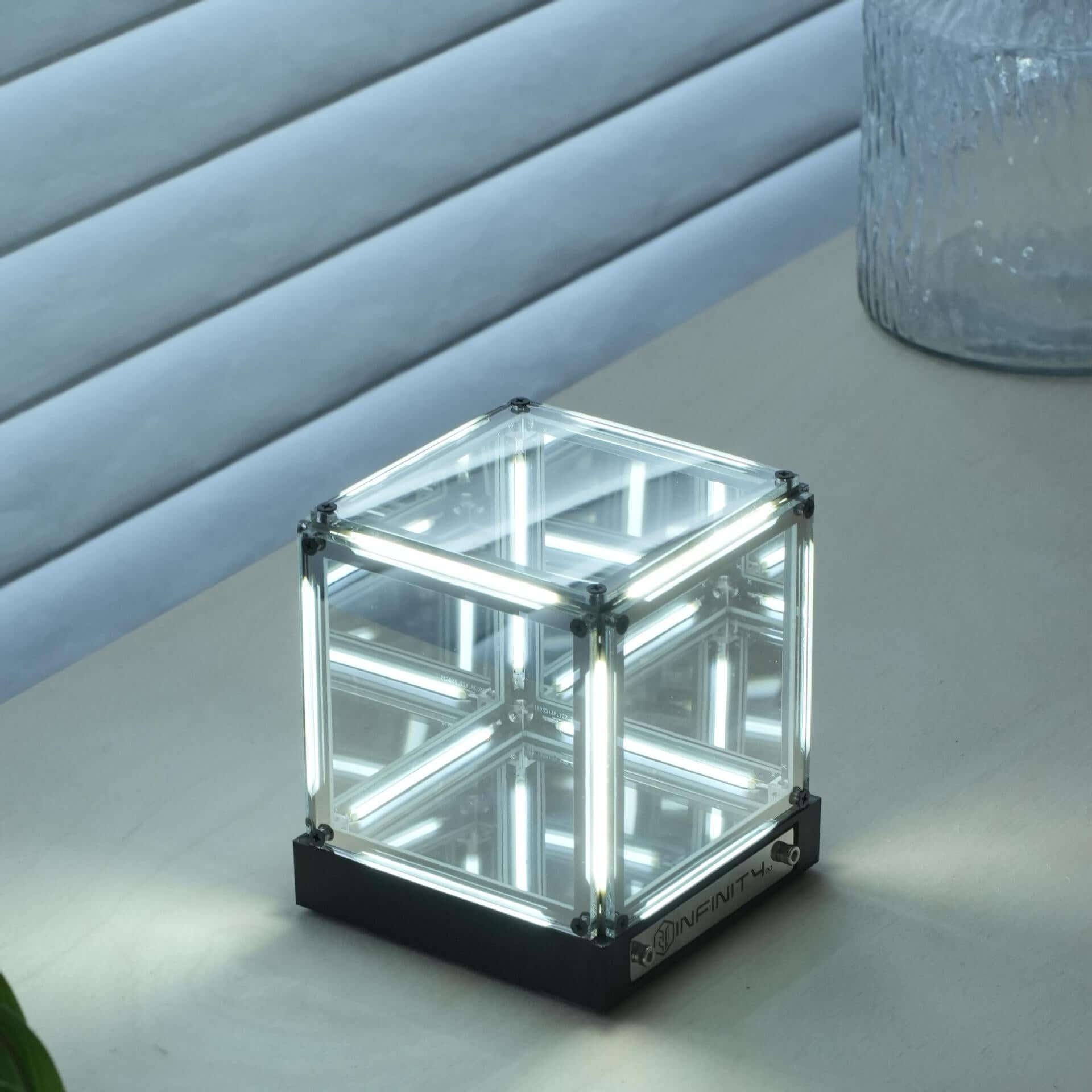 Interstellar Cube | 4D Abyss Infinity Mirror & Desk Lamp glowing on a table with mirrored reflections.