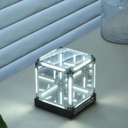 Interstellar Cube | 4D Abyss Infinity Mirror & Desk Lamp glowing on a table with mirrored reflections.