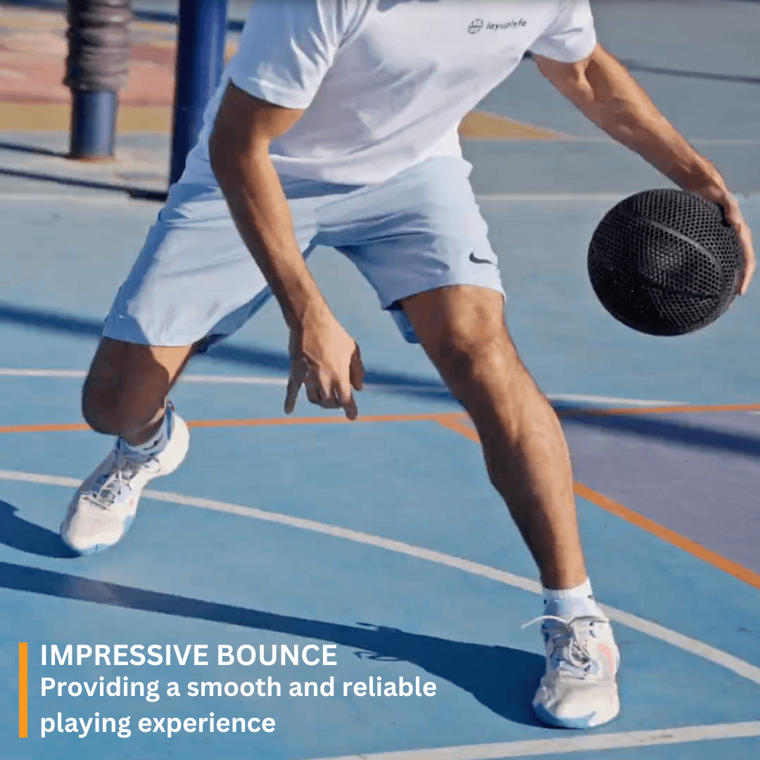 Man dribbling a 3D printed airless basketball on a court, showcasing impressive bounce and performance.