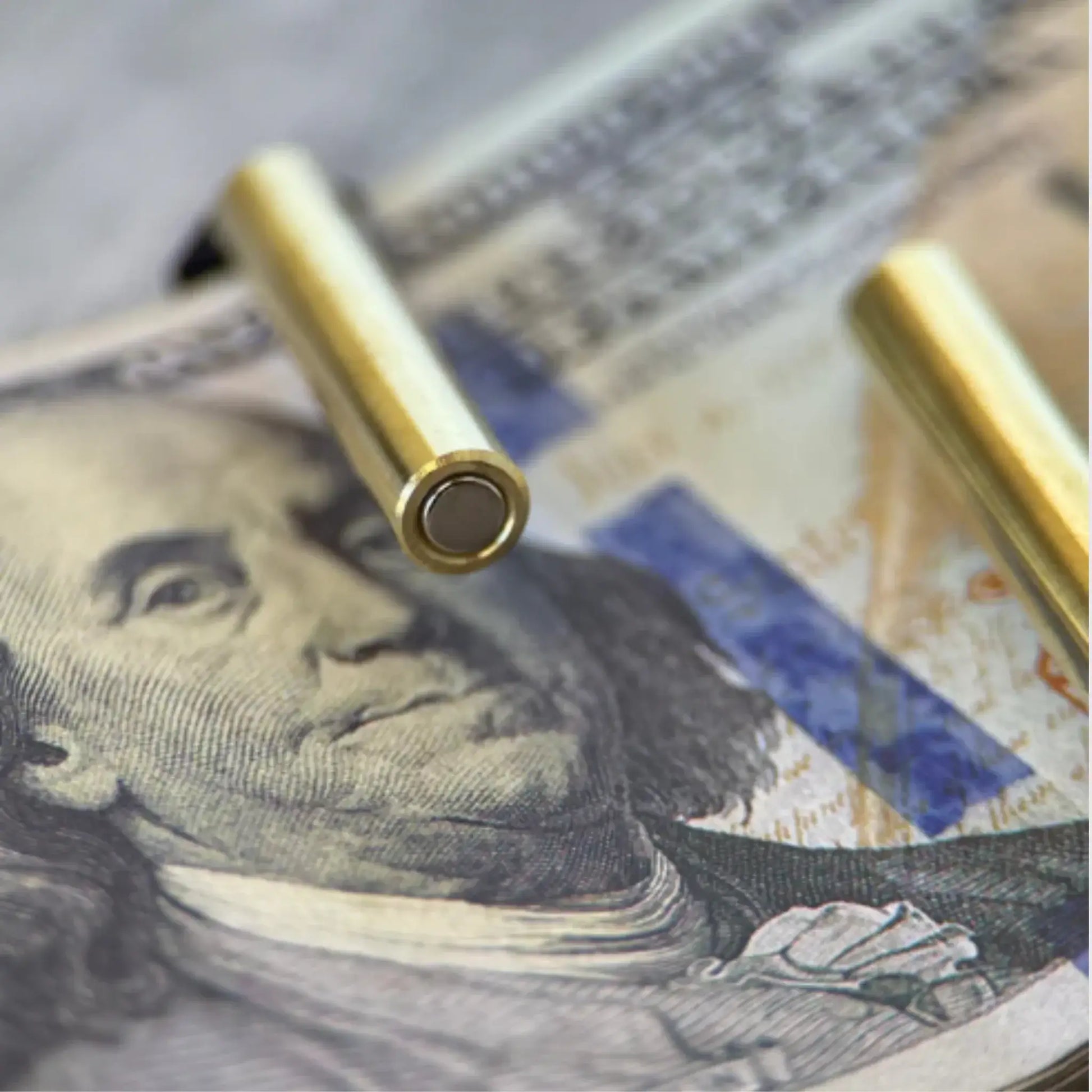Close-up of premium genuine leather cash wrap wallet with golden snap closure on dollar bills.