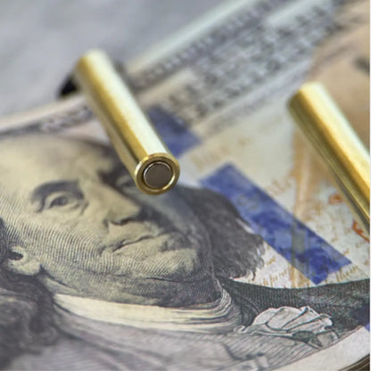 Close-up of premium genuine leather cash wrap wallet with golden snap closure on dollar bills.
