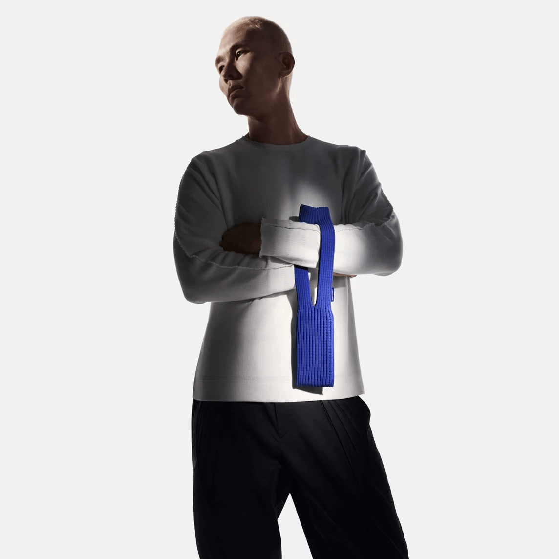 Model showcasing the Mobile Pocket accessory in a stylish setup, highlighting its unique design and vibrant blue color.
