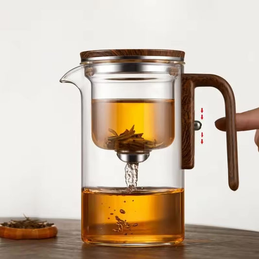 One-Click Magnetic Teapot featuring tea-water separation, a glass body, and a natural wood handle. Premium Lifestyle Gear.