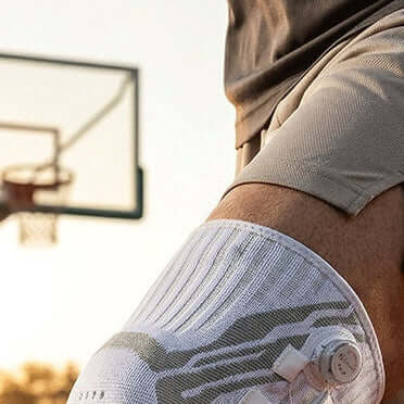 Knob Style Knee Pads on a basketball player, featuring advanced mechanical compression for joint stabilization.