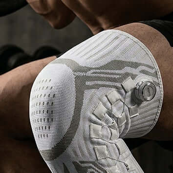 Close-up of Knob Style Knee Pads showcasing mechanical compression and adjustment dial system.