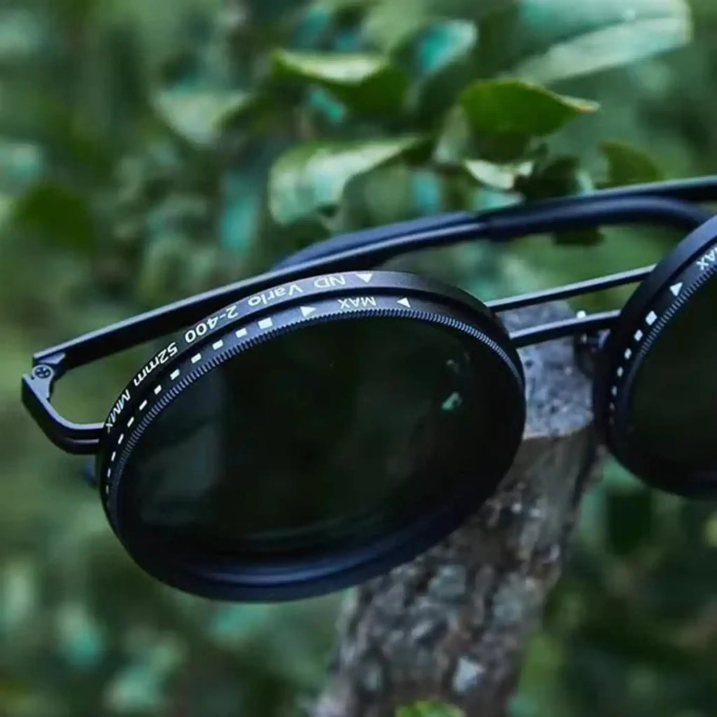 Adjustable Tint Sunglasses: SmartShade HD on a tree branch showcasing ND filter lenses.