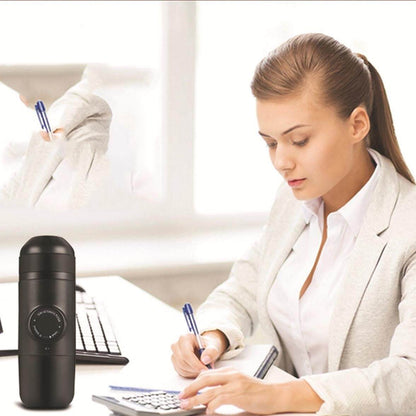 Portable Hand Espresso Maker next to a focused woman working at her desk