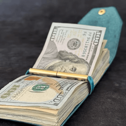 The Cash Wrap Wallet in premium synthetic leather, a minimalist slim bill holder shown from the front view filled with cash.