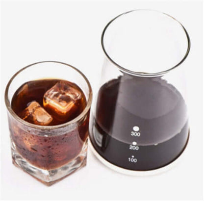 Cold drip coffee maker featuring a glass container and a drink with ice cubes, showcasing smooth coffee extraction.