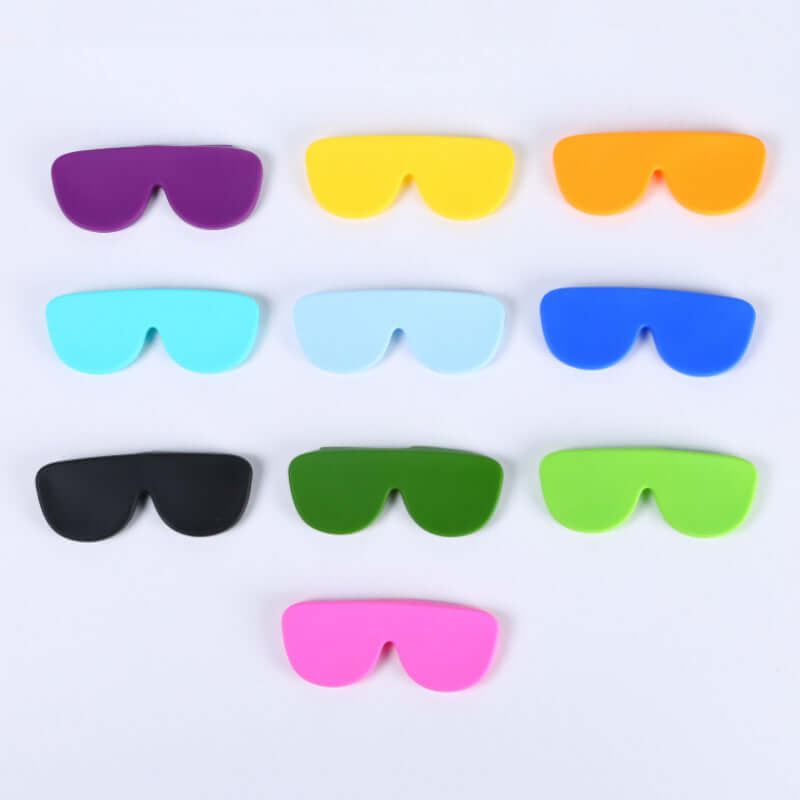 Colorful selection of oversized silicone eyewear protectors in purple, yellow, orange, blue, green, black, and pink.