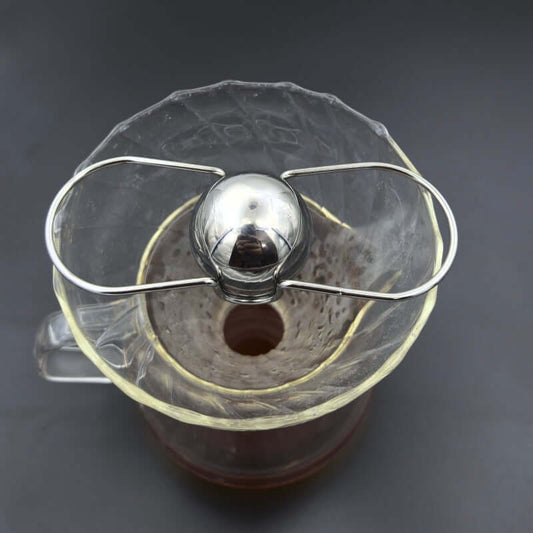 Espresso Chilling Ball resting over a coffee decanter, designed to chill espresso with zero dilution.
