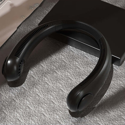 Leafless Hanging Neck Fan on a soft surface, showcasing the hands-free wearable cooling band in sleek black design.