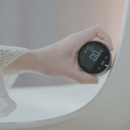 A hand in a white, lacy sleeve holds the PrecisionCore HD High Precision Electronic Measuring Ruler Tool, showing a 0.0 reading on its digital display near the edge of a white bathtub.