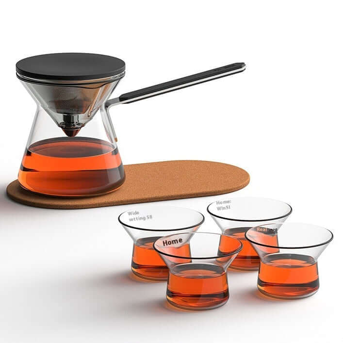 Magnetic Tea Pot and four glass cups with brewed tea on a cork mat, highlighting a modern brewing experience.