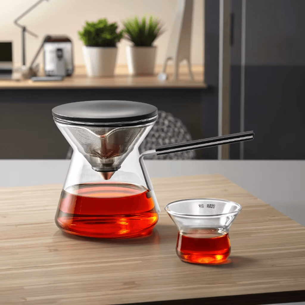 Magnetic Tea Pot displayed on a wooden table, featuring a press-type infuser with brewed tea in a cup.