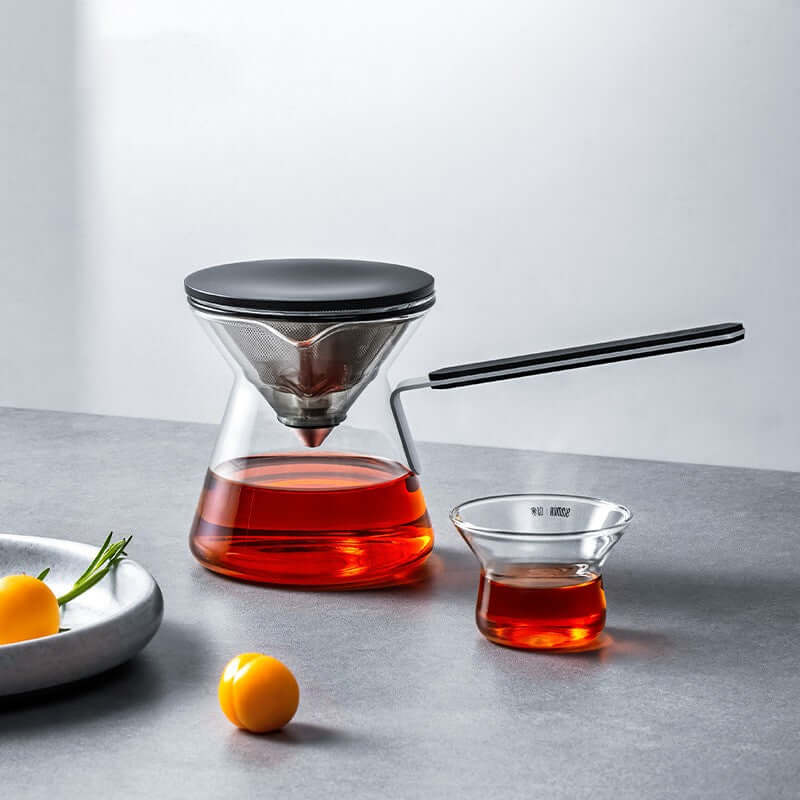 Magnetic Tea Pot in Chroma Glass with tea infusion and tea cup on a modern countertop