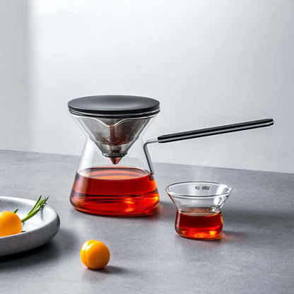 Magnetic Tea Pot in Chroma Glass with tea infusion and tea cup on a modern countertop