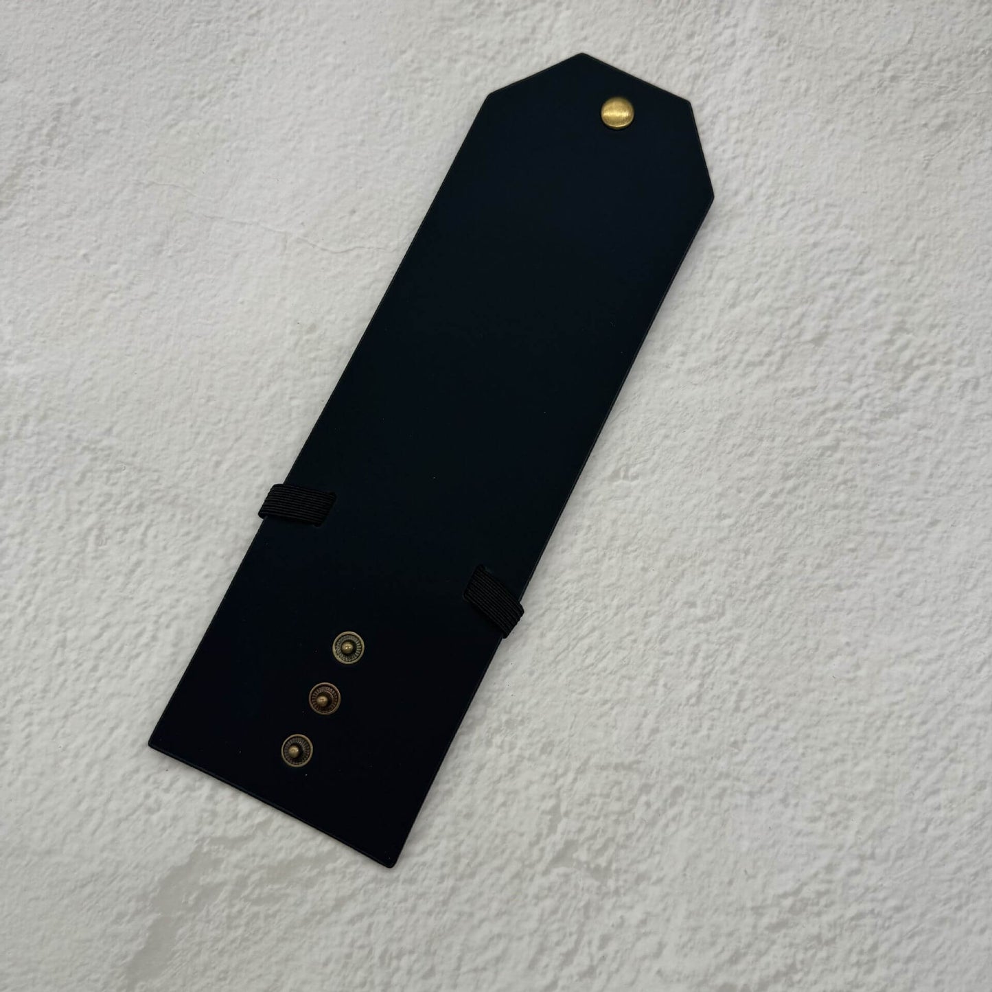 The Cash Wrap Wallet in premium synthetic leather, a minimalist slim bill holder shown from the front view filled with cash.