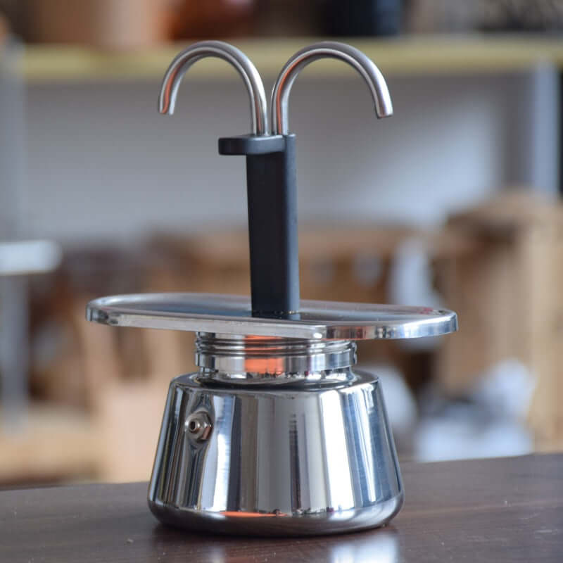 Modern Moka Pot – Premium Unique Design Stainless Steel Espresso Maker on a wooden surface.