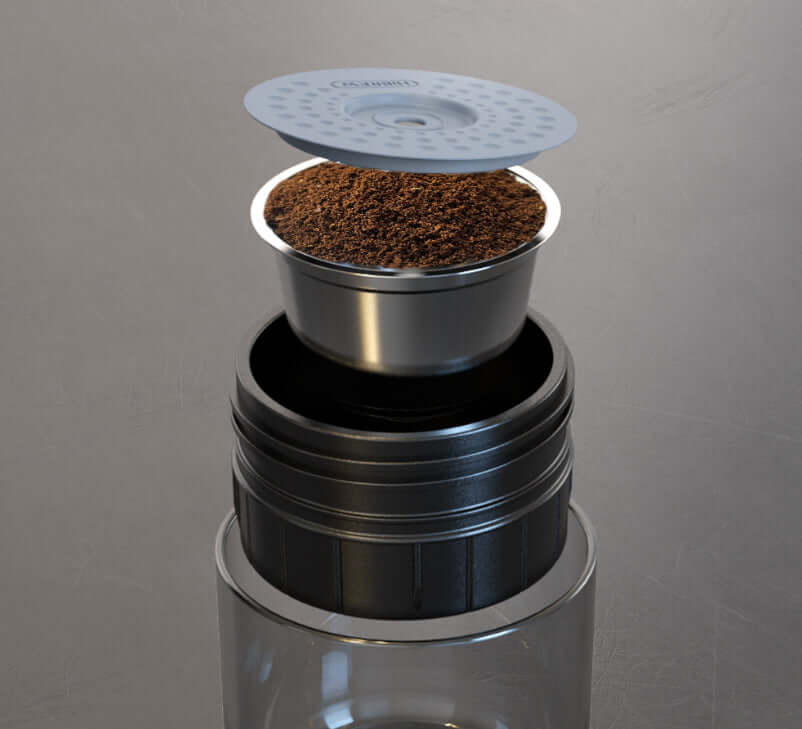 Portable Electric Espresso Maker with coffee pod and filter ready for brewing.