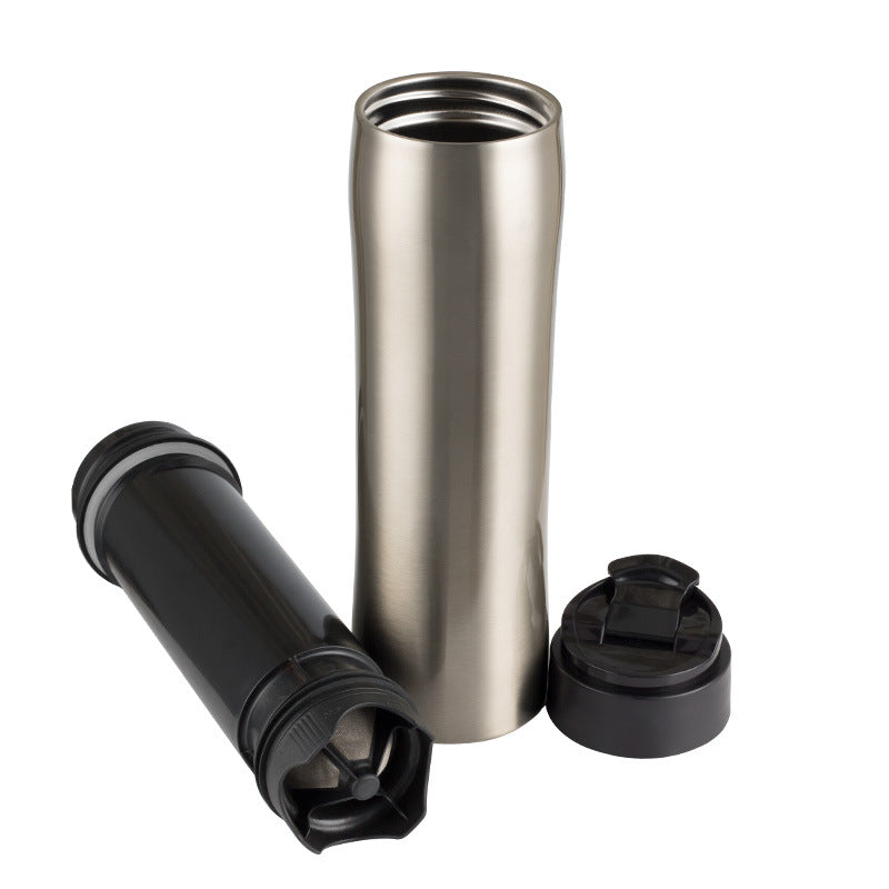 Portable Espresso Maker and accessories including a stainless steel body and a black cap for travel.