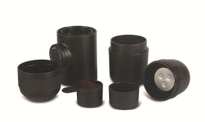Portable Hand Espresso Maker accessories including black containers and measuring scoop for travel coffee brewing.