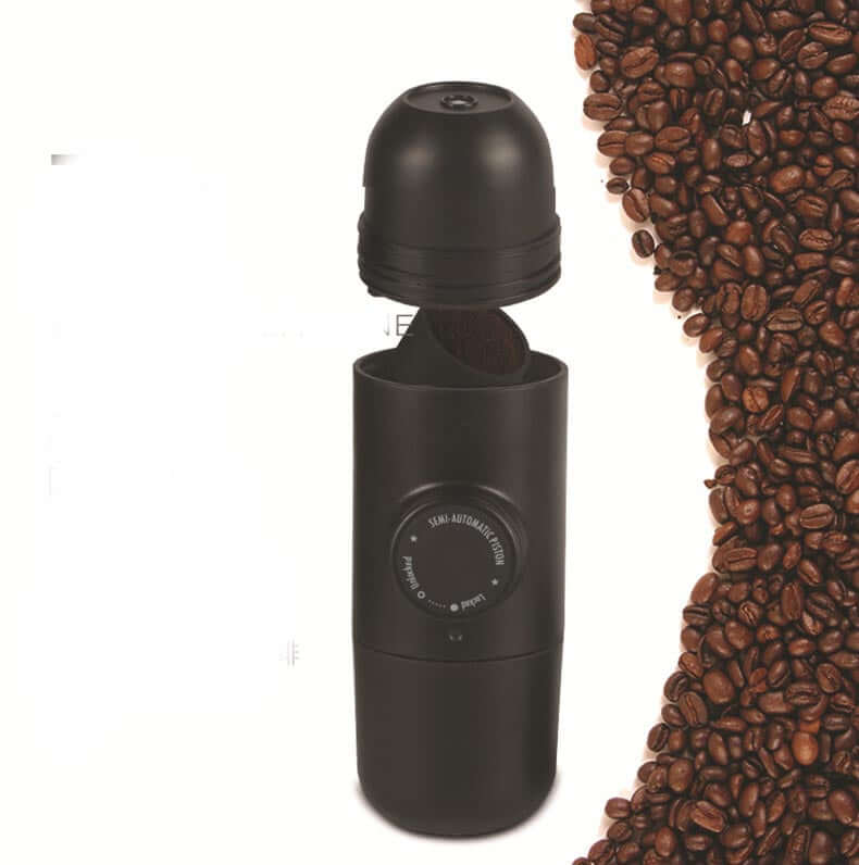 Portable Hand Espresso Maker next to coffee beans, ideal for making espresso on the go.