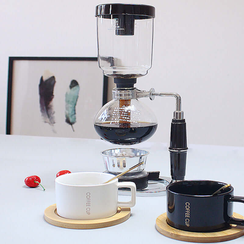 Premium Siphon Coffee Maker featured with coffee cups on a stylish countertop.