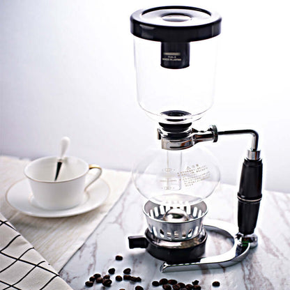 Premium Siphon Coffee Maker on countertop with coffee beans and cup.