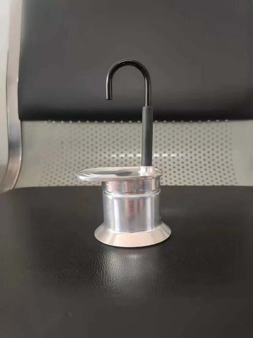 Single-Shot Aluminum Moka Pot with a classic octagonal design and heat-resistant handle on a minimalist kitchen counter.