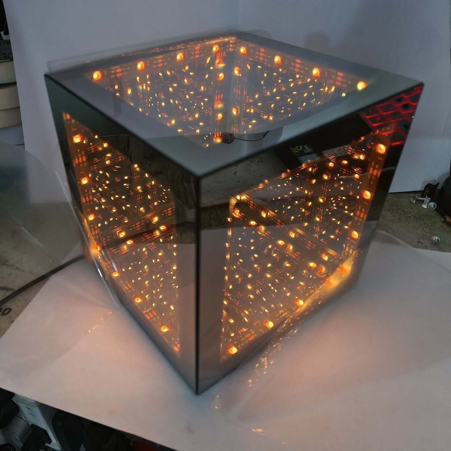 Tesseract Abyss Lamp – Infinity Mirror Hypercube Desktop Light showcasing geometric LED illusion cube and infinity mirror tunnel light.