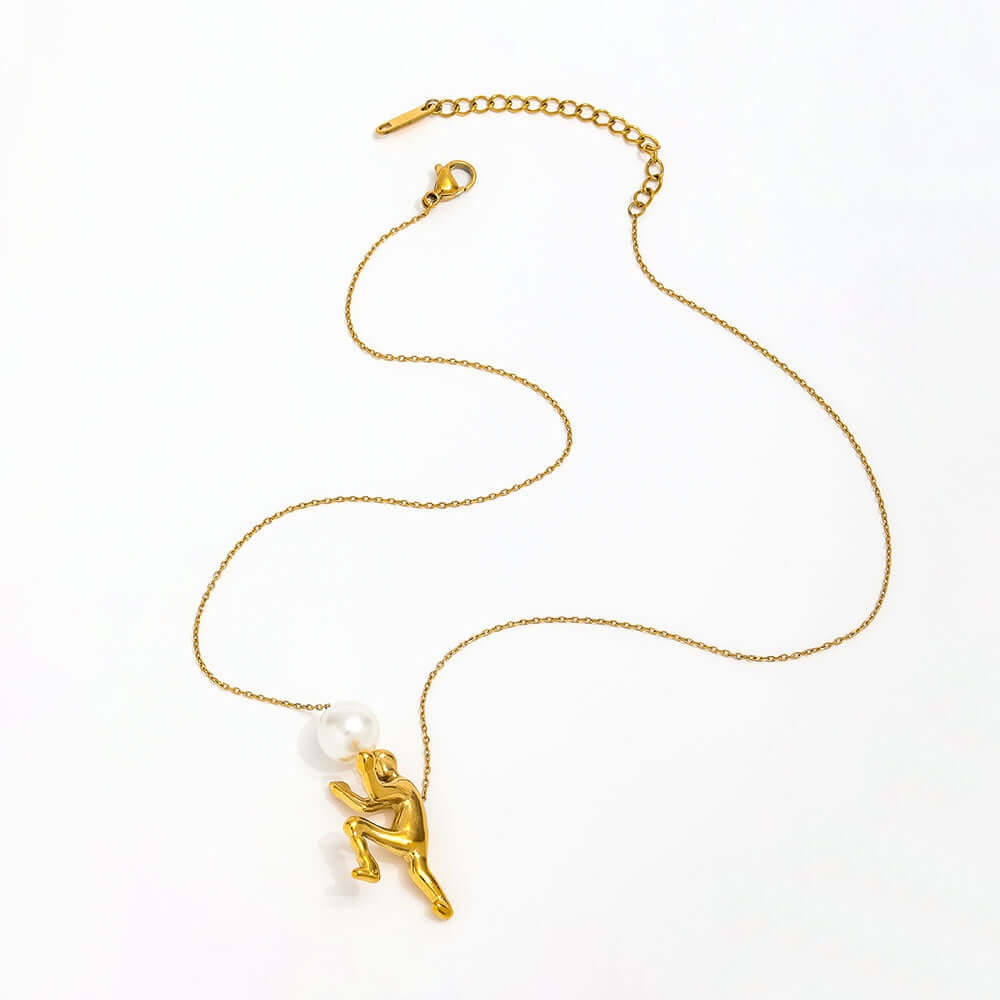 The Ambition Pearl Necklace featuring a sculpted figure and centerpiece pearl, symbolizing strength and persistence.