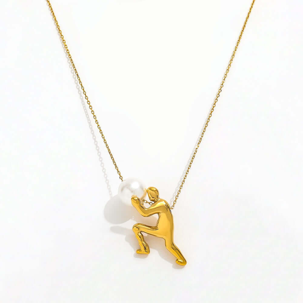 The Ambition Pearl Necklace featuring a gold figure supporting a pearl, symbolizing strength and persistence.