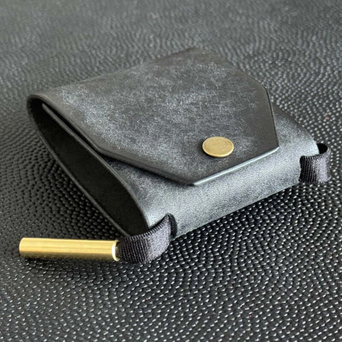The Cash Wrap Wallet in premium synthetic leather, a minimalist slim bill holder shown from the front view filled with cash.
