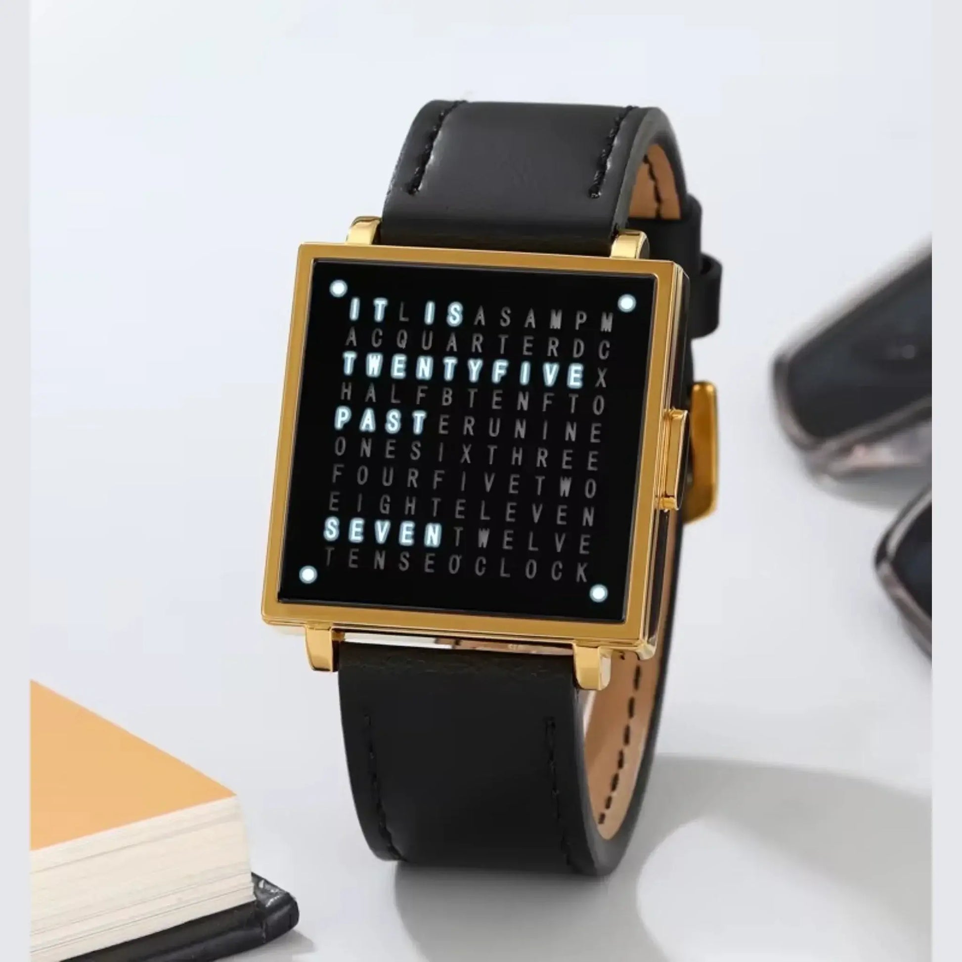 Retro digital watch featuring a square dial with word clock design on black leather strap.