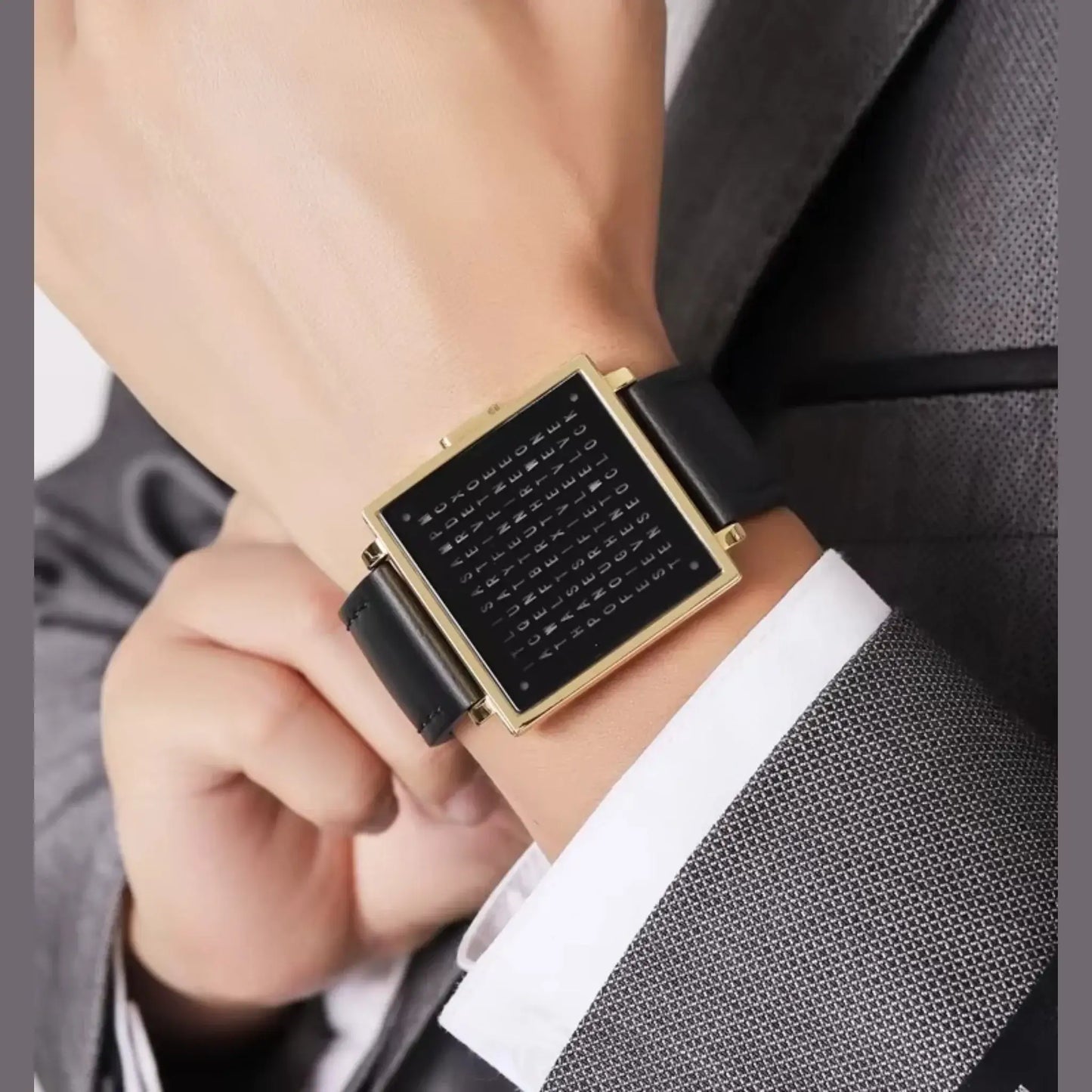 Close-up of a stylish retro digital watch with a square black dial and leather strap, worn on a businessman's wrist.