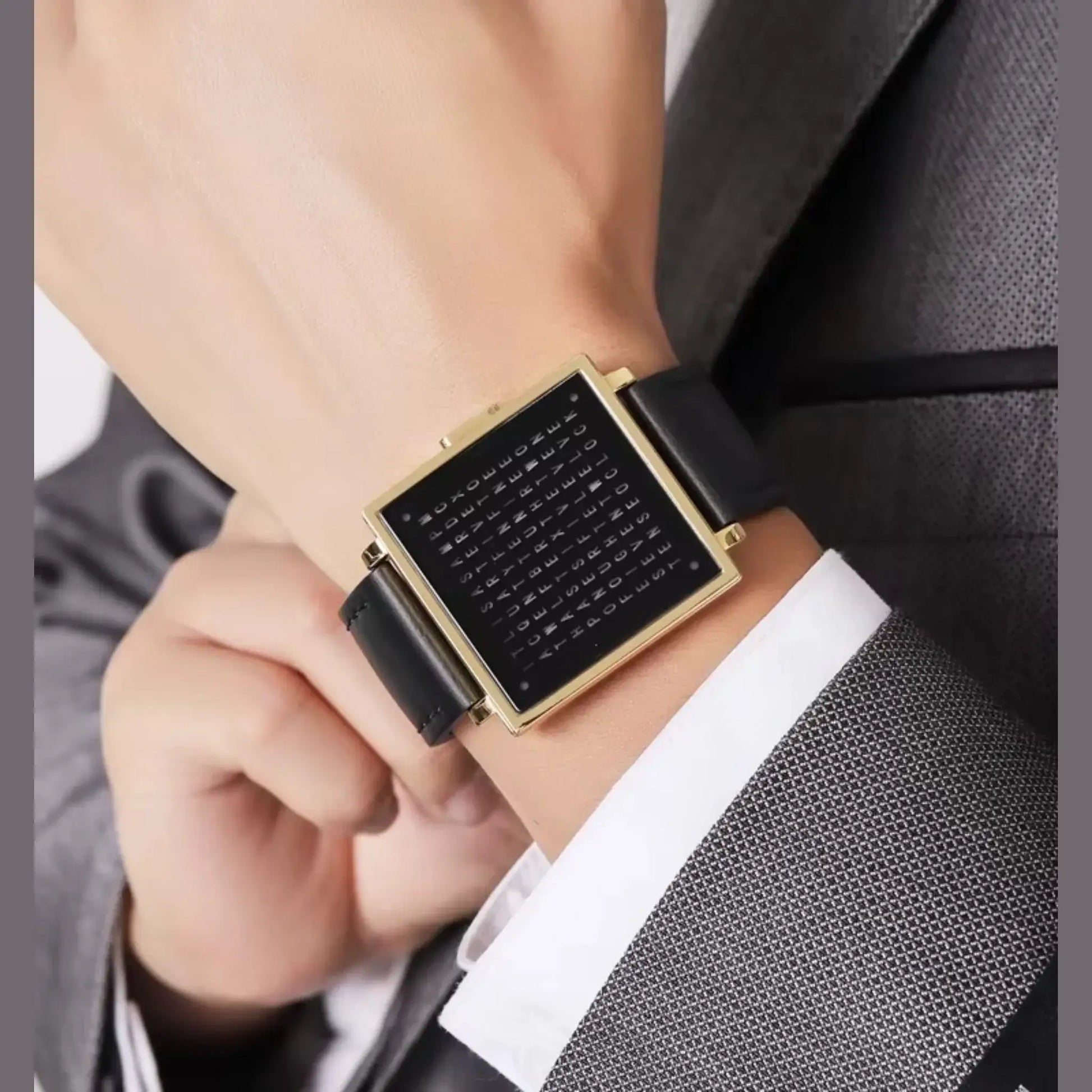 Close-up of a stylish retro digital watch with a square black dial and leather strap, worn on a businessman's wrist.